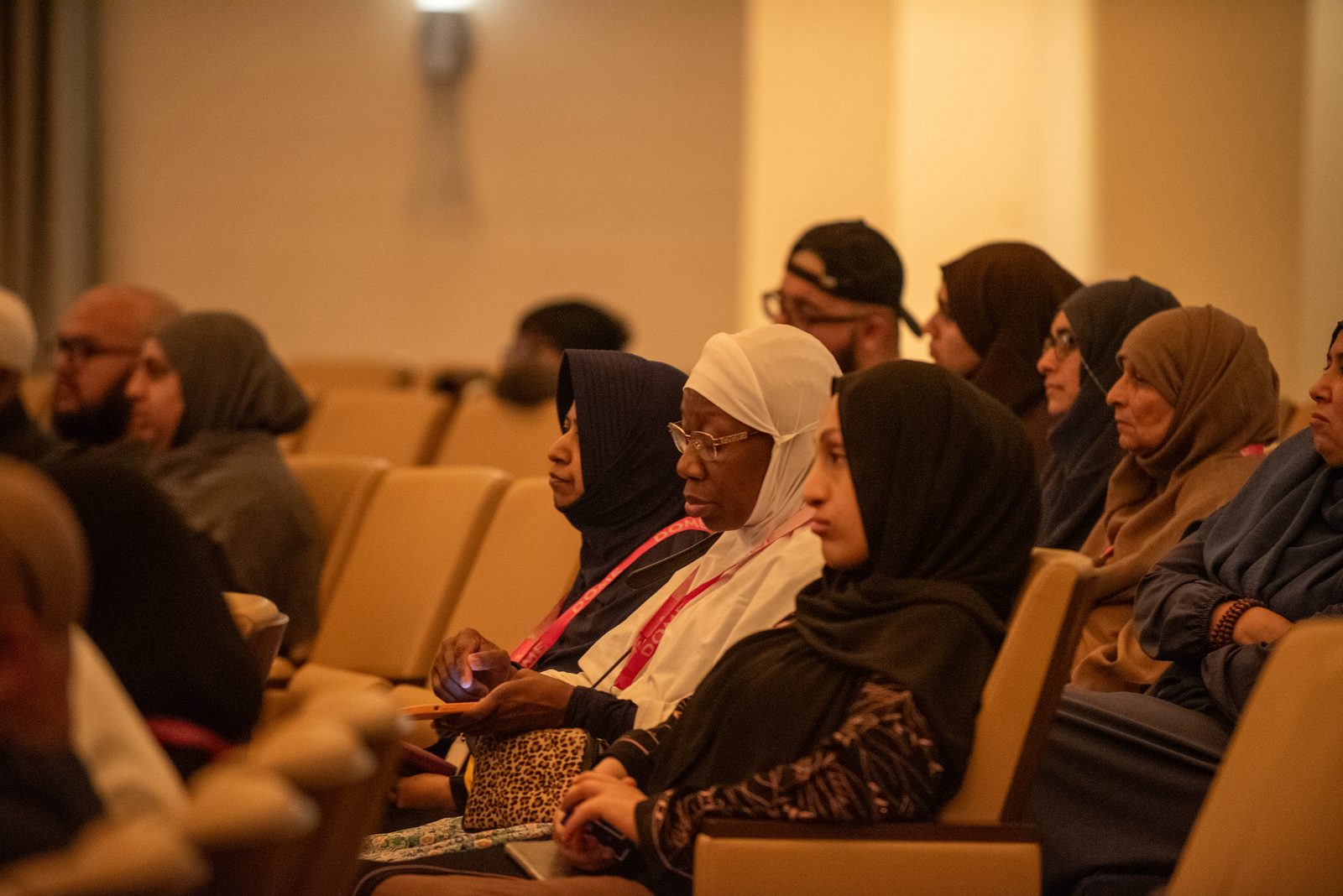 Pilgrims listening intently during an education session