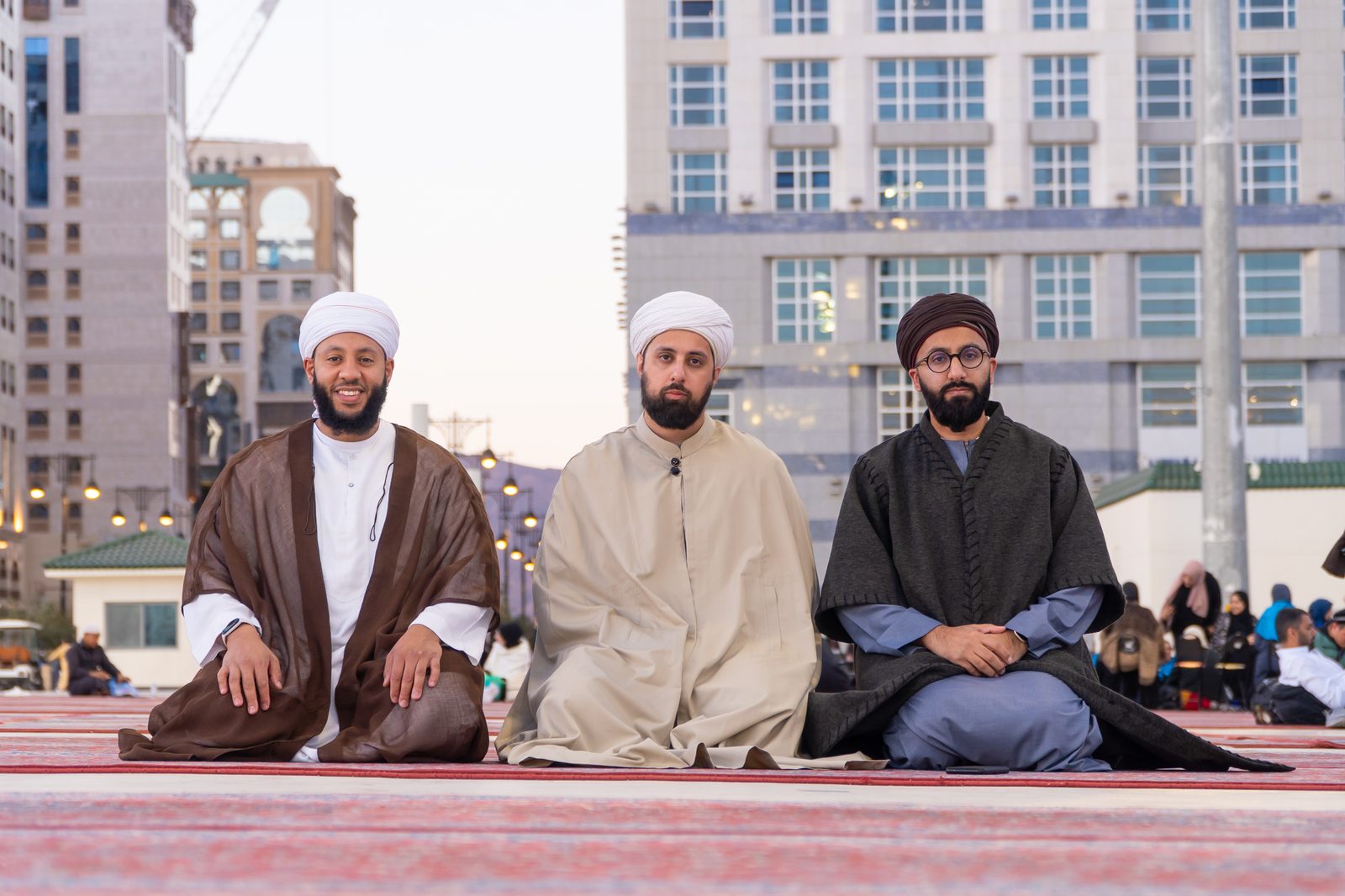 Scholars sitting in prayer in front of the Prophet's Mosque