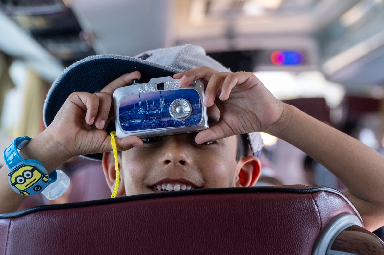 A young pilgrim looking through binoculars during a site visit